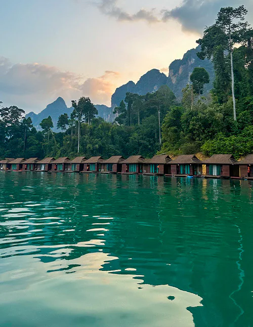 Flytende bungalower på smaragdgrønn innsjø i Thailand