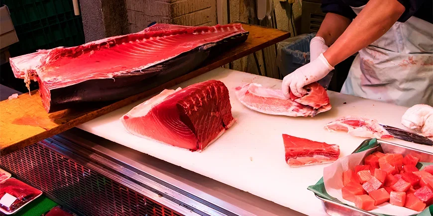 Det skjæres tunfisk på Tsukiji fiskemarked i Tokyo